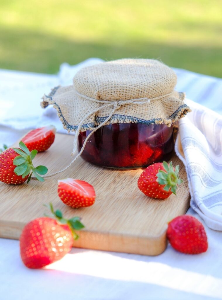 Fresh strawberries and a jar of homemade jam